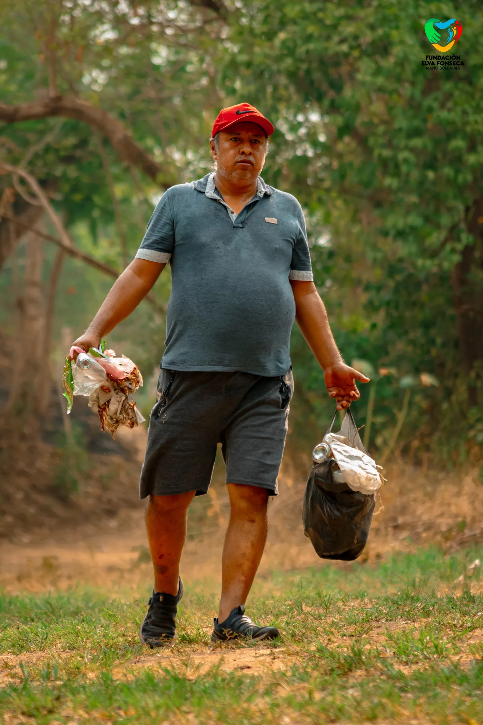 A community sponsor wearing a red cap outdoors